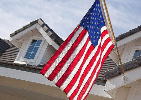 An American Flag Hanging from Home with Home Insurance in Monroe, MI