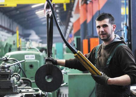 Worker using tools in car repair shop with Business Insurance in Monroe, MI