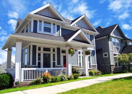 Two Story Home with Plants Hanging Near Front Porch with Home Insurance in Monroe, MI